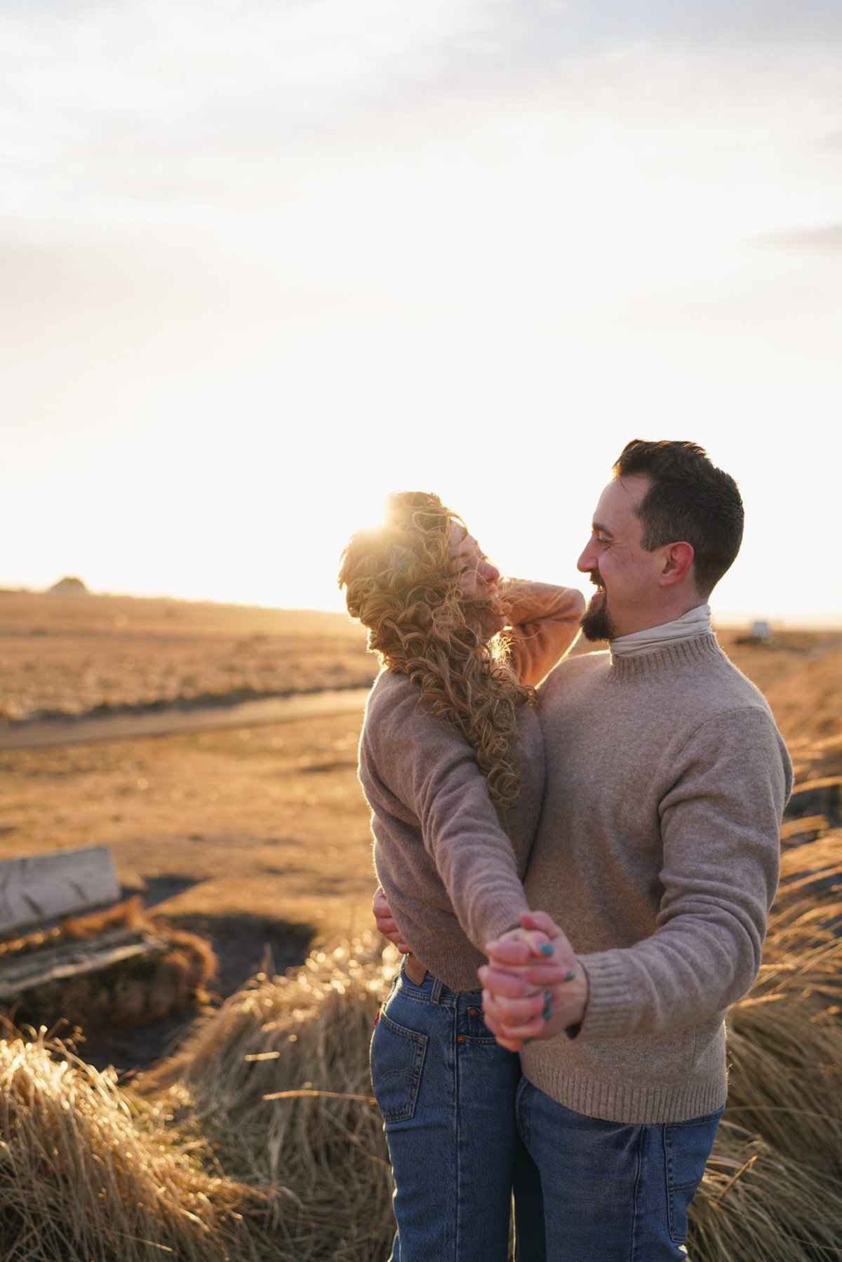 Austin and Ana dancing close and laughing in golden light