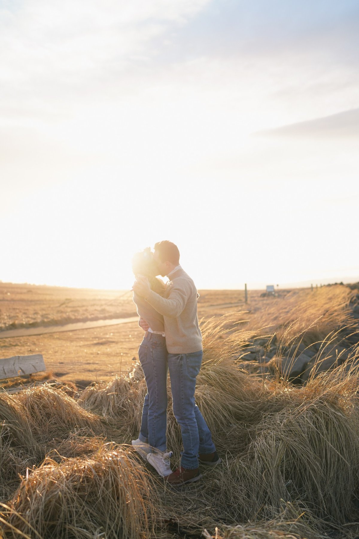 Austin and Ana kissing into the setting sun